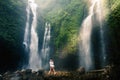 Amazing romantic view of happy couple near beautiful grand waterfall