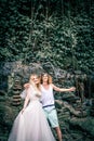 Amazing romantic view of happy couple in the rainforest of Bali island close to waterfall. Royalty Free Stock Photo