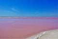 Amazing salt lake. Smooth pink surface, bright blue sky, clean sand.