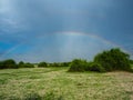 Amazing scene of double rainbow on blue sky copy space background above natural sand, grass and tree on savanna plain, Chobe Royalty Free Stock Photo