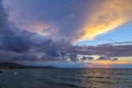 Amazing scenic landscape taken during wonerful sunset on sea. island Crete in background with clouds and water in red