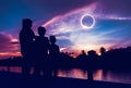 Natural phenomenon. Three person looking at total solar eclipse.