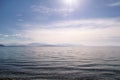 Amazing sea, sky, beautiful clouds and sun, majestic landscape with seascape at calm blue water on horizon of mediterranean coast. Royalty Free Stock Photo