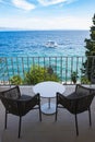 Amazing sea view balcony with chairs and desk and boat