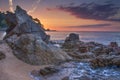 Amazing seascape with rocks and stones on beach at sunrise. Beautiful colorful sky at dawn over idyllic mediterranean nature Royalty Free Stock Photo