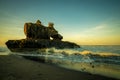 Amazing seascape. Sunrise at Yeh Gangga beach. Rock in the ocean. Natural hole in rock formation. Slow shutter speed. Long