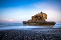 Amazing seascape. Sunrise at Yeh Gangga beach. Rock in the ocean. Waves captured with slow shutter speed. Long exposure with soft Royalty Free Stock Photo