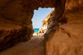 Amazing seascape view from unique sea cave on famous Rotonda beach. Tourists walking through the grotto, resting on small beach.