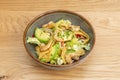 amazing shrimp salad, avocado, strips of corn chips, iceberg lettuce, lots of parsley and oil in a gray bowl Royalty Free Stock Photo