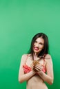 Amazing Smiling Brunette in Bright Swimwear Posing with Cocktail in Studio on Green Background. Royalty Free Stock Photo