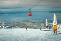 Winter ski resort with skiers and cable car, Transylvania, Romania