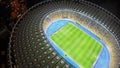 Amazing soccer stadium, glowing night lights, aerial view, sport event building Royalty Free Stock Photo