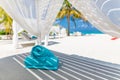 Tranquility beach lounge canopy. Relax carefree scene, towel pillows and beds in sunny tropical weather