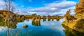 Amazing sunny day on lake Myvatn, Iceland, Europe. Volcanic rock formations reflected in the blue clear water of a volcanic lake.
