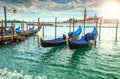 Amazing sunrise with gondolas harbor in Venice, Italy, Europe