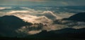 Amazing sunrise in the mountains. Great view of the foggy valley with bright sun rays in Carpathians.