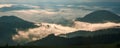 Amazing sunrise in the mountains. Great view of the foggy valley with bright sun rays in Carpathians.