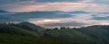 Amazing sunrise in the mountains. Great view of the foggy valley with bright sun rays in Carpathians.