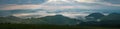 Amazing sunrise in the mountains. Great view of the foggy valley with bright sun rays in Carpathians.