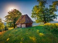 Amazing sunrise Romanian village with traditional peasant house. Royalty Free Stock Photo