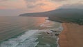 Amazing sunrise sea shore aerial view. Foamy waves rolling to sandy empty beach Royalty Free Stock Photo