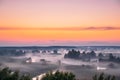 Amazing Sunrise Sunset Over Misty Landscape. Scenic View Of Foggy Morning Sky Above Misty Forest And River. Early Summer Royalty Free Stock Photo