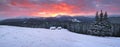 Amazing sunrise. Winter forest. Old wooden huts on the lawn covered with snow. High mountains with snow white peaks. Wallpaper Royalty Free Stock Photo