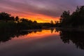 Amazing sunset above a pond with reflections in the water near Waterschei in Belgium