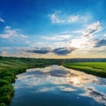 Amazing sunset in a blue cloudy sky over a river with green banks. Ukraine landscape Royalty Free Stock Photo