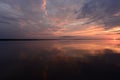 Amazing sunset colors on the lake in the calmness weather in a summer evening Royalty Free Stock Photo