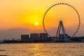 Amazing sunset colors over the sea view to the Ain Dubai, giant Ferris at Bluewaters Island close to JBR beach. Royalty Free Stock Photo