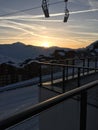 High chair lift in th sky in fornt of the sunset in french alps