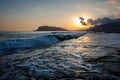 Amazing sunset, and incredible foamy waves. Hill in the background