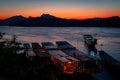 Amazing sunset in luang prabang over the mekong river. Tourist and house boats in the water. Sky is on fire.