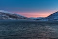 Amazing sunset with amazing magenta color over fjord Tromso, Norway. Polar night. long shutter speed Royalty Free Stock Photo