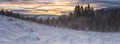 Amazing sunset mountain panoramic view, nature winter landscape with fir trees, snow, and colorful sky with clouds, outdoor travel Royalty Free Stock Photo