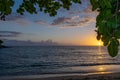 Amazing sunset on Negril Jamaica beach. The sun kisses the horizon as it sets for the evening. Royalty Free Stock Photo