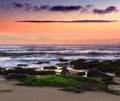 Amazing  sunset on the ocean. View of dramatic colorful sky and stony beach in the rays of the sun.  Atlantic coast near Lisbon. P Royalty Free Stock Photo