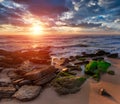 Amazing  sunset on the ocean. View of dramatic colorful sky and stony beach in the rays of the sun.  Atlantic coast near Lisbon. P Royalty Free Stock Photo