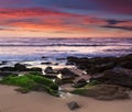 Amazing  sunset on the ocean. View of dramatic colorful sky and stony beach in the rays of the sun.  Atlantic coast near Lisbon. P Royalty Free Stock Photo