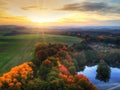 Amazing sunset over the autumnal forest and lake in Poland Royalty Free Stock Photo