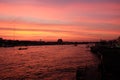 Amazing sunset over the Chao Phraya River in Bangkok. Silhouettes of buildings by the river