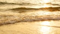 Amazing sunset over the tropical beach. ocean beach waves on beach at sunset time , sunlight reflect on water surface. Royalty Free Stock Photo