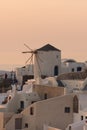 Amazing Sunset over white windmills in town of Oia and panorama to Santorini island, Thira, Greece Royalty Free Stock Photo