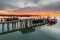 Amazing sunset on the palatial pier of Carrasqueira, Alentejo, Portugal. Wooden artisanal fishing port Royalty Free Stock Photo