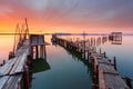 Amazing sunset on the palatial pier of Carrasqueira, Alentejo, Portugal. Wooden artisanal fishing port, with traditional boats on Royalty Free Stock Photo