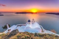 Amazing sunset at Panagia Theoskepasti, on the Skaros rock at Imerovigli, Santorini, Crete, Greece