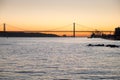 Amazing sunset on Ponte 25 de Abril Bridge, (25th of April Bridge) at Lisbon