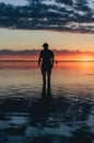 Silhouette of a person in a lake and the reflection of a sunset Royalty Free Stock Photo