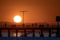 Amazing  sunset scene projecting silhouette of people on the dock Royalty Free Stock Photo